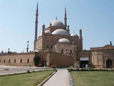 The majestic Ottoman-style architecture of the Mosque of Muhammad Ali at the Citadel of Saladin, featuring its grand silver-toned domes and twin slender minarets.